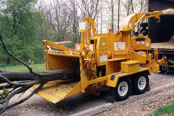Wood chipper processing tree limbs